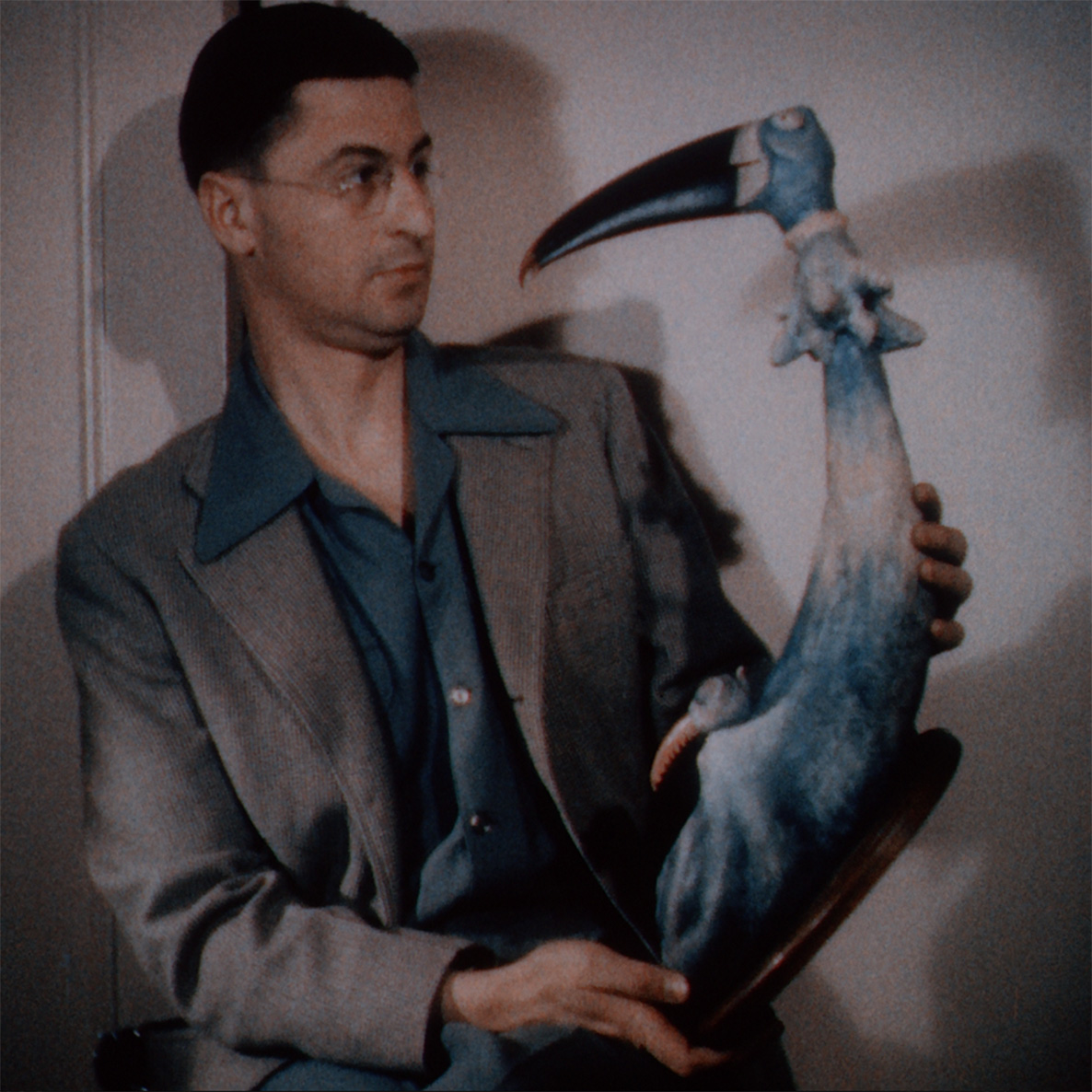 Man holding a plastic bird